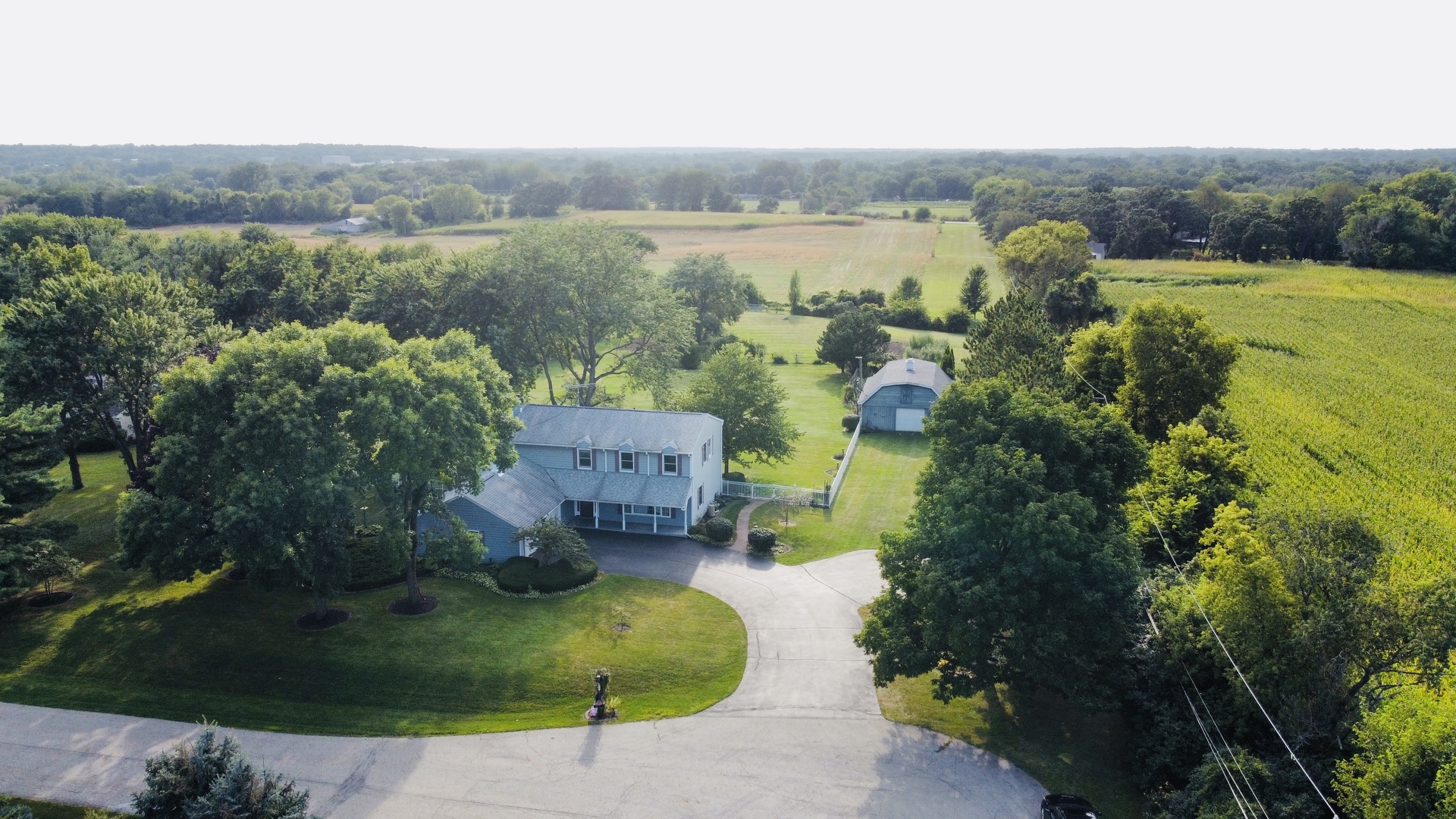 8515 Schmidt Street Spring Grove, IL 60081 - Photo 3 of 43 an aerial view of a house with a garden and a yard