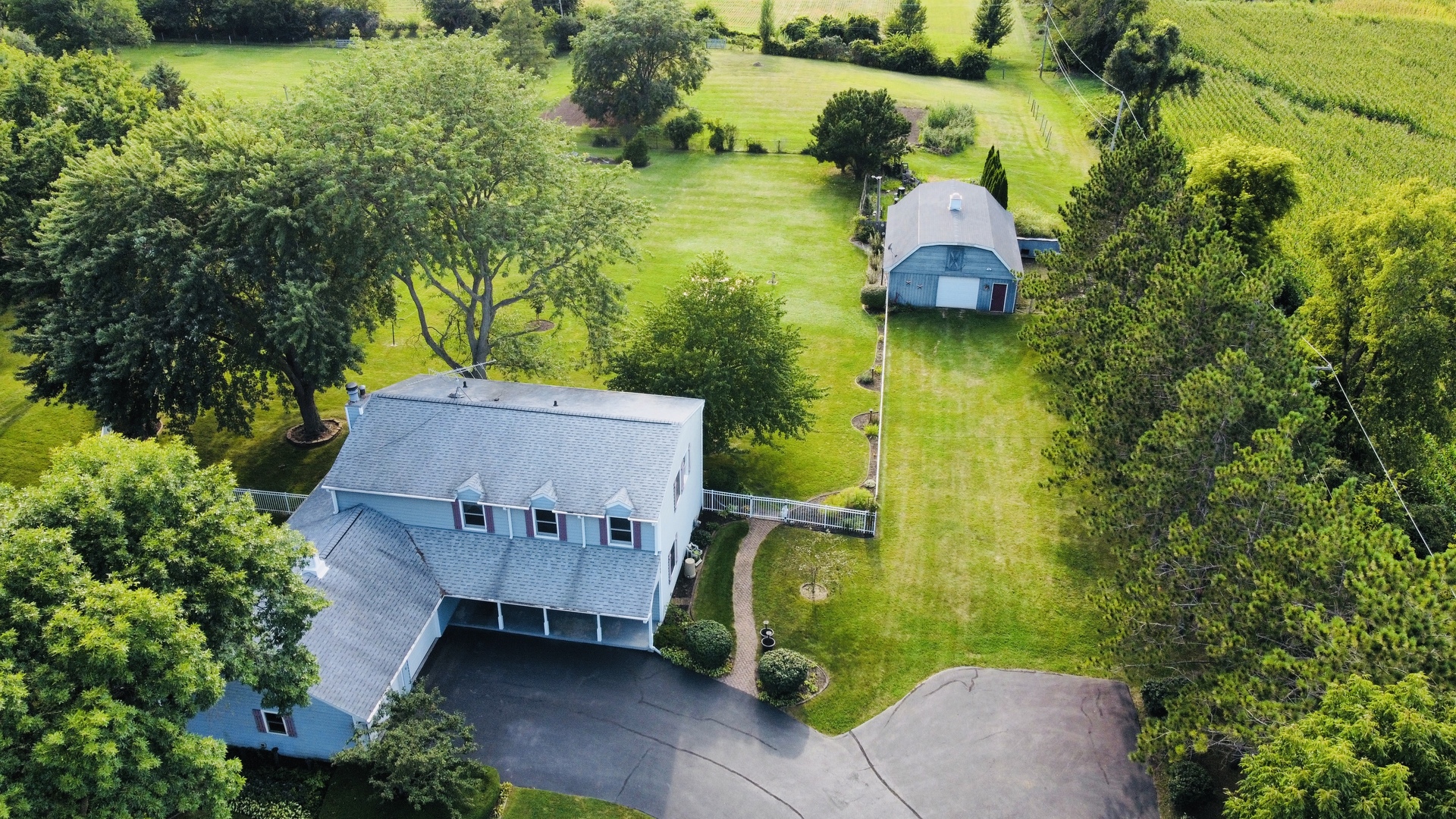 8515 Schmidt Street Spring Grove, IL 60081 - Photo 4 of 43 an aerial view of a house with swimming pool and large trees