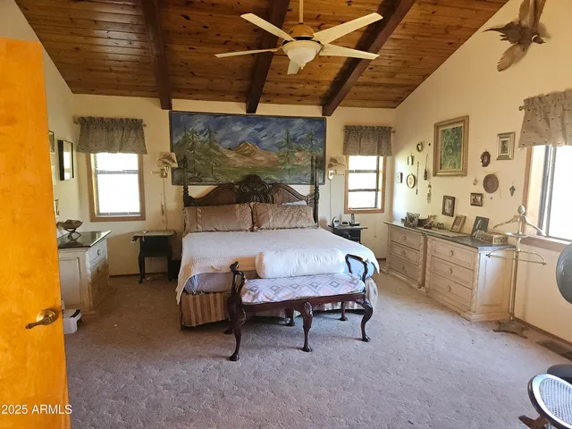 a bedroom with a bed a mirror and a desk