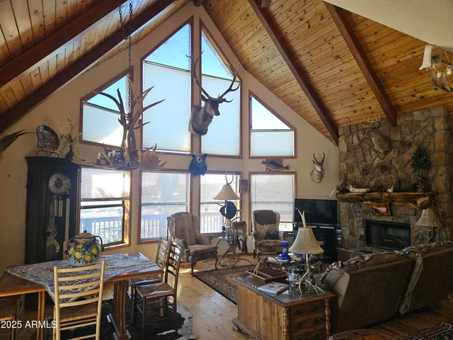 a living room with fireplace furniture and a large window
