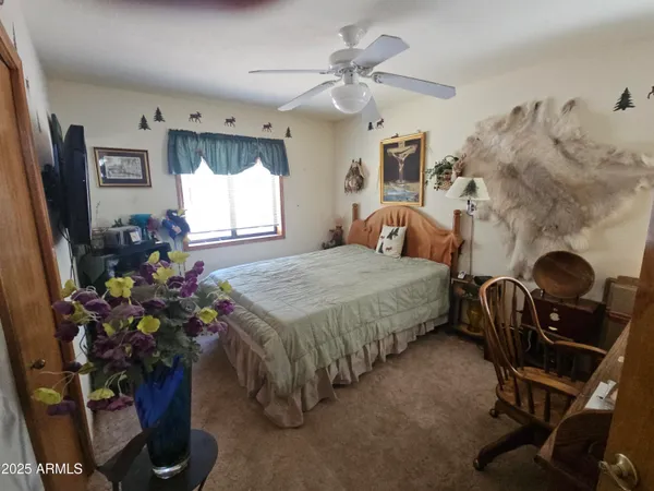 a bedroom with a bed mirror and window