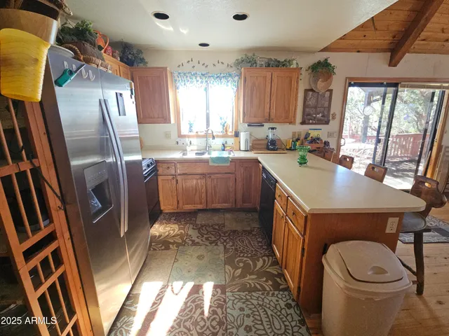 a kitchen with a sink appliances and cabinets