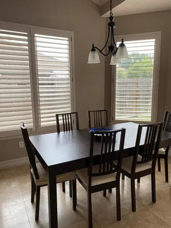 a view of a dining room with furniture and window