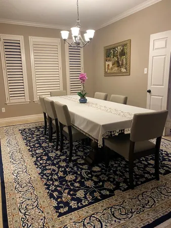 a dining room with a table and chairs
