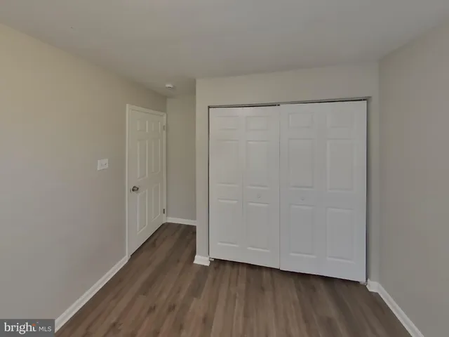 a view of an empty room and wooden floor