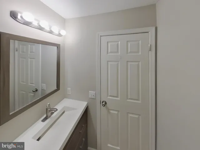 a bathroom with a sink a vanity and a mirror