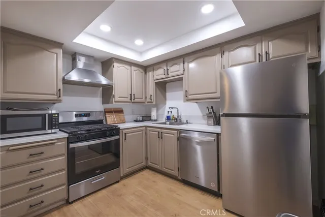 a kitchen with stainless steel appliances granite countertop a stove a refrigerator and a refrigerator