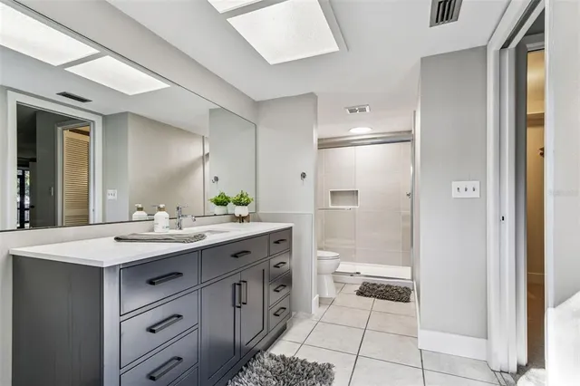 a en suite bathroom with a sink and mirror