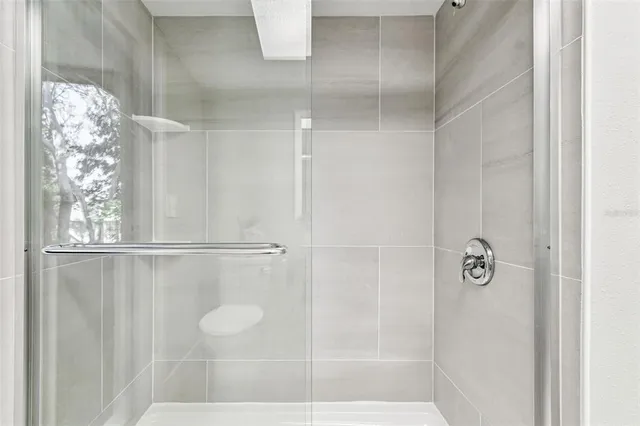 an aerial view of residential houses with outdoor space and trees all around