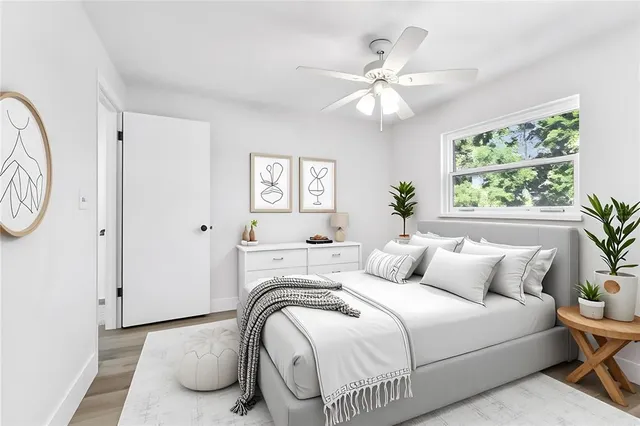 an aerial view of residential houses with outdoor space and trees