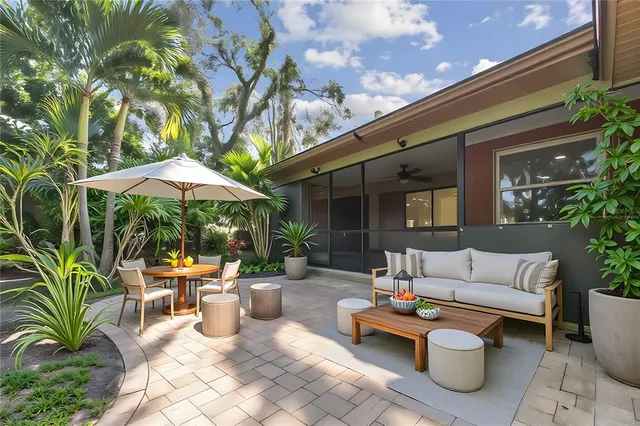a view of a swimming pool with lawn chairs and a big yard