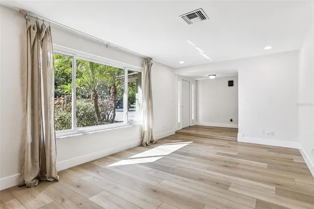 a kitchen with stainless steel appliances granite countertop a sink window and cabinets