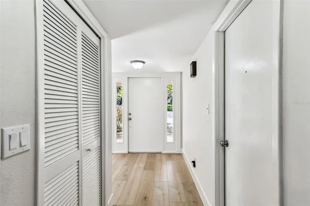 a large kitchen with a sink dishwasher a stove and a refrigerator with wooden floor