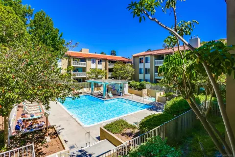 a view of a house with pool and sitting area