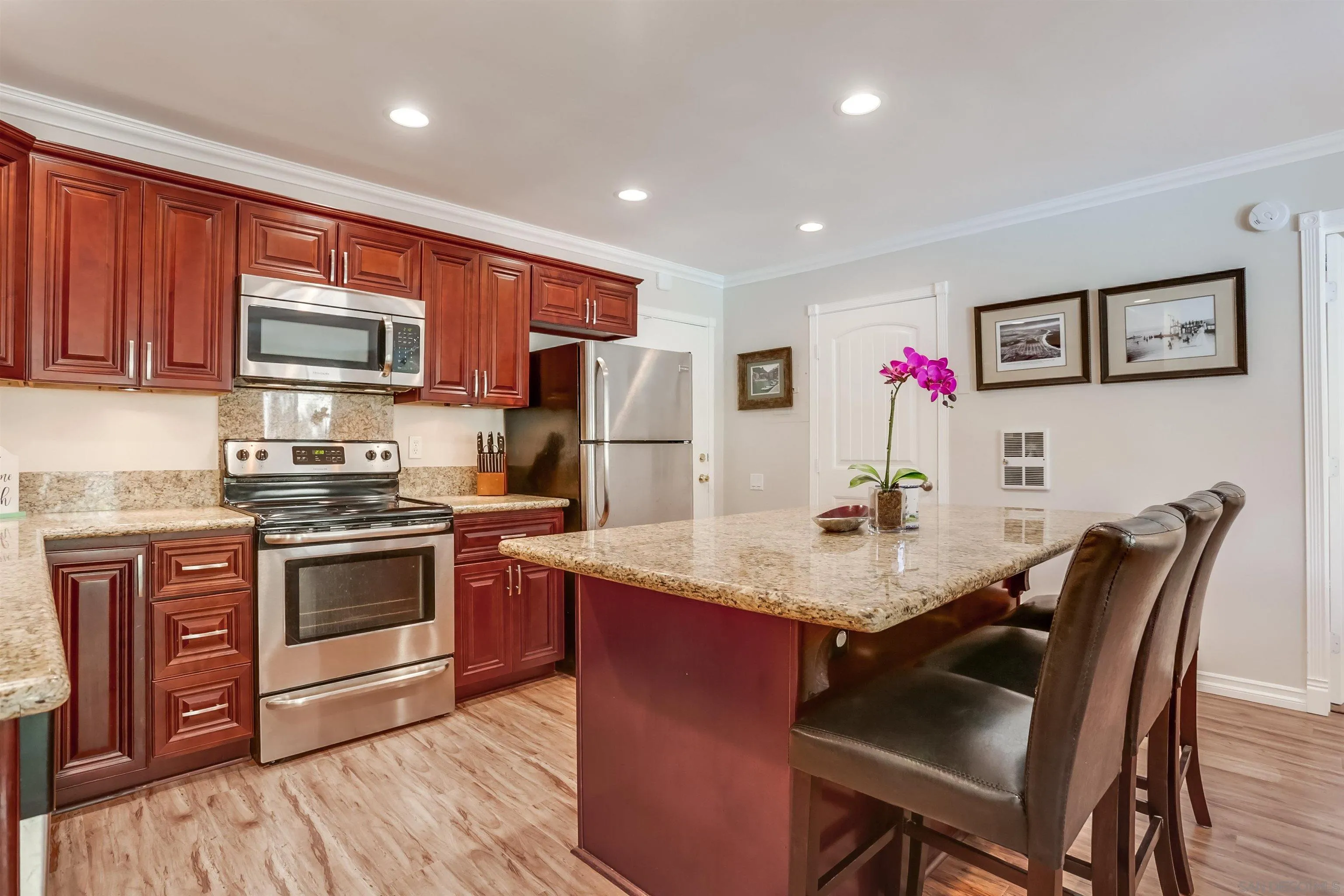 a kitchen with stainless steel appliances granite countertop a stove refrigerator and a microwave