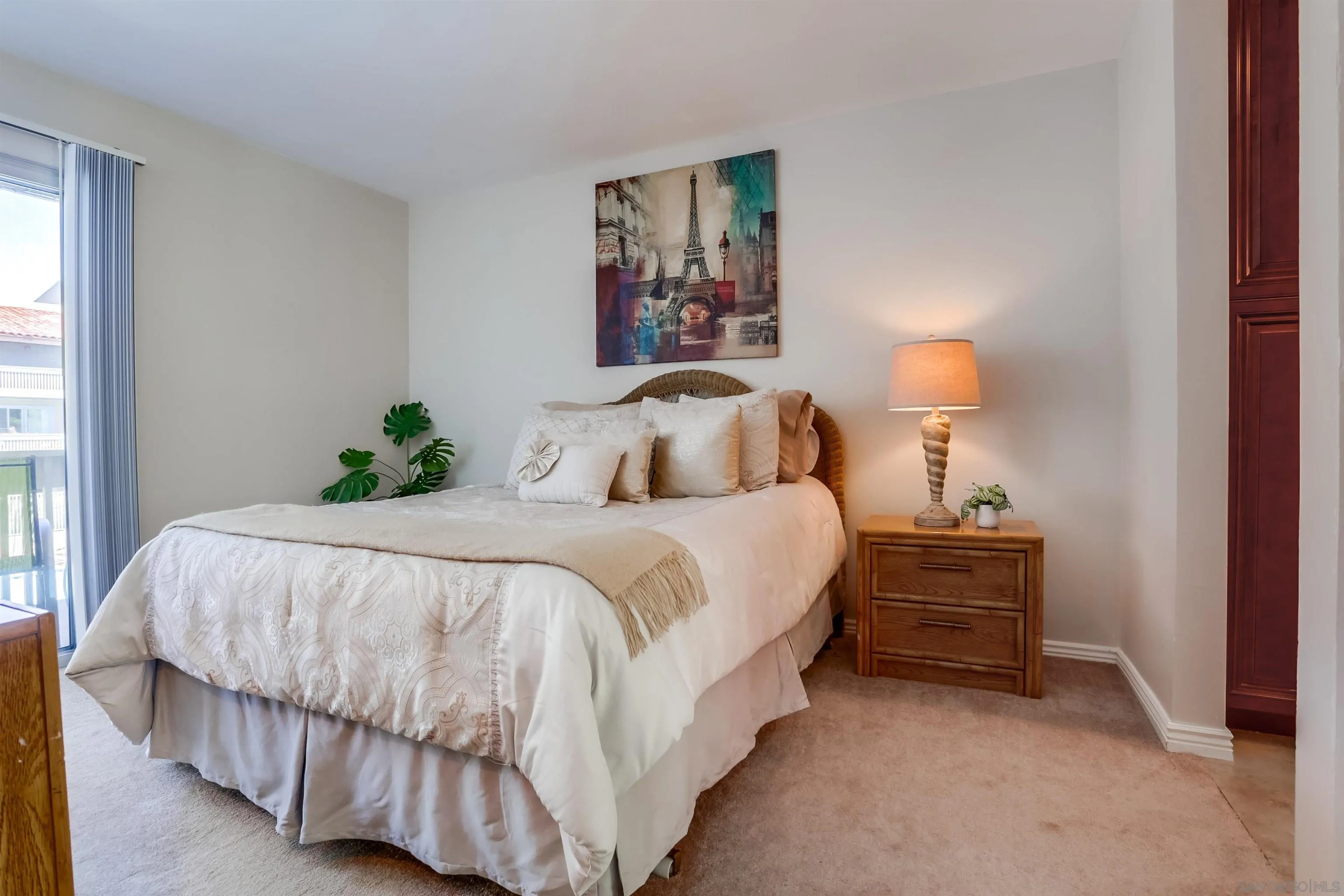 1775 Diamond Street, Unit 220 San Diego, CA 92109 - Photo 11 of 21 a large bed sitting in a bedroom next to a window