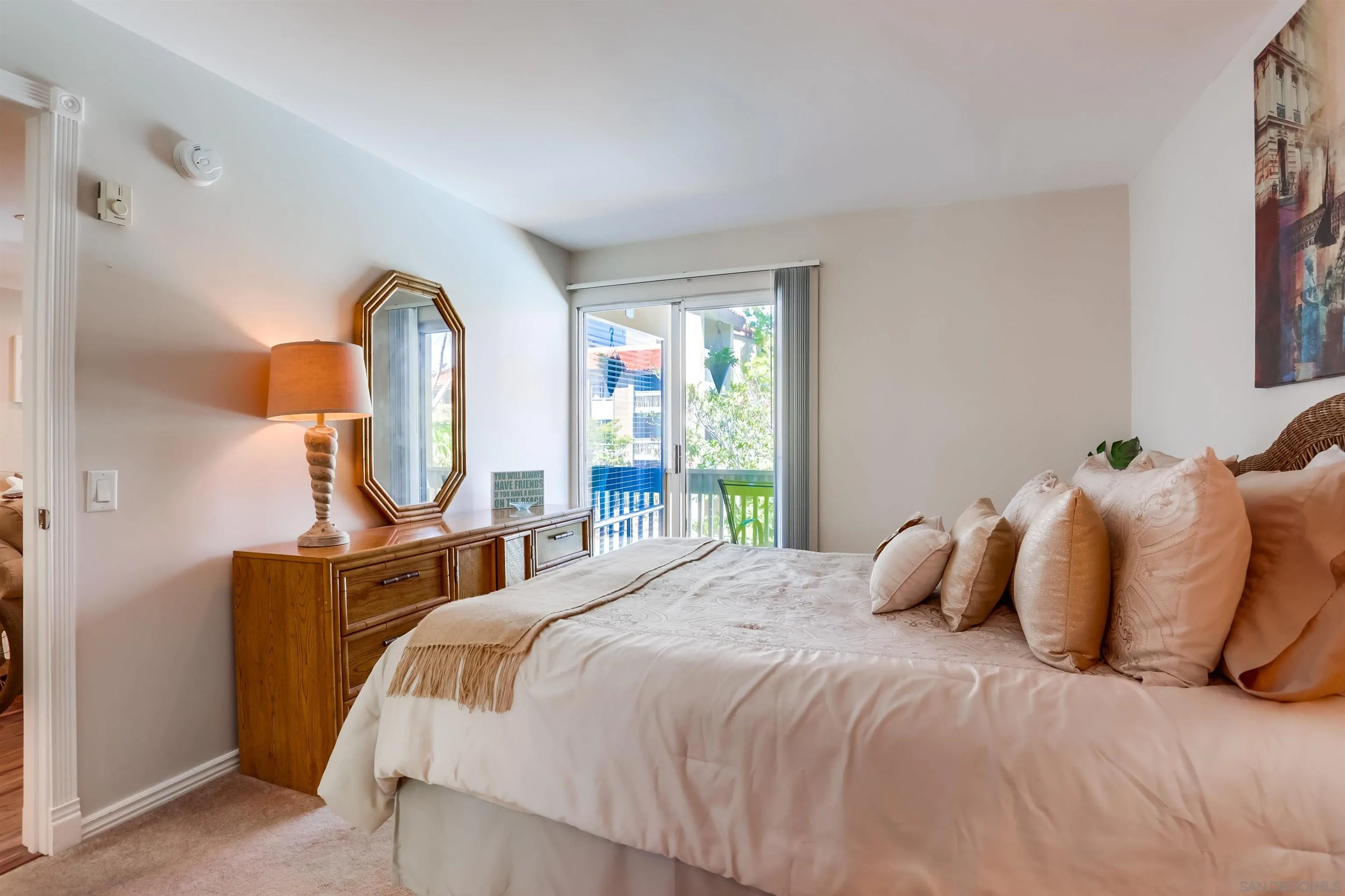 1775 Diamond Street, Unit 220 San Diego, CA 92109 - Photo 12 of 21 a bedroom with a bed a mirror and a window