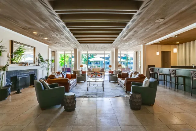 a living room with fireplace furniture and a large window