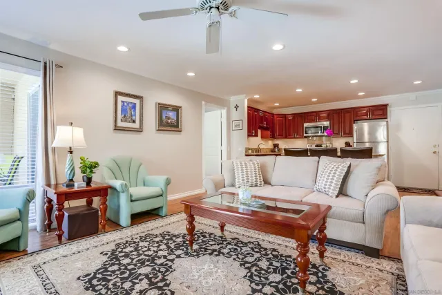 a living room with furniture and kitchen view