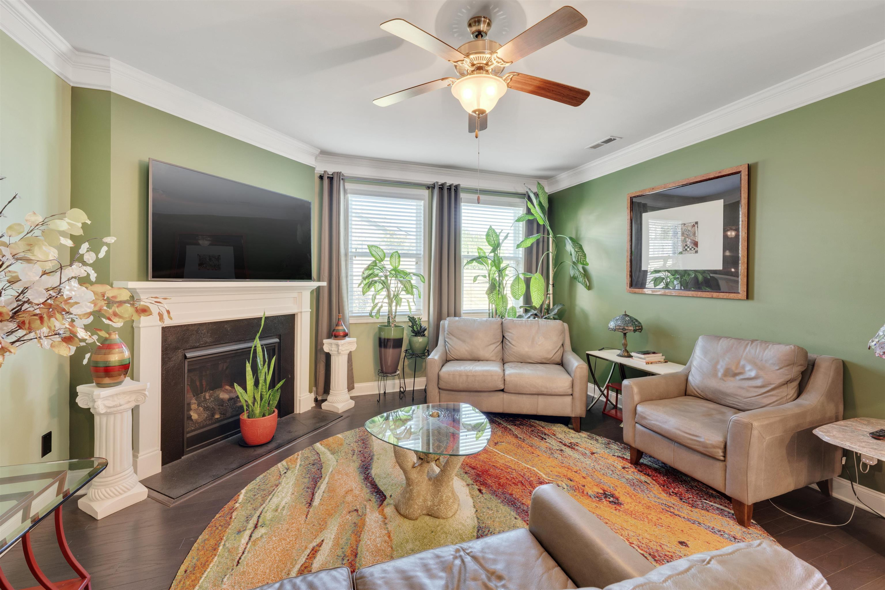 5317 Maplemoor Way Raleigh, NC 27616 - Photo 12 of 25 a living room with furniture a fireplace and a flat screen tv
