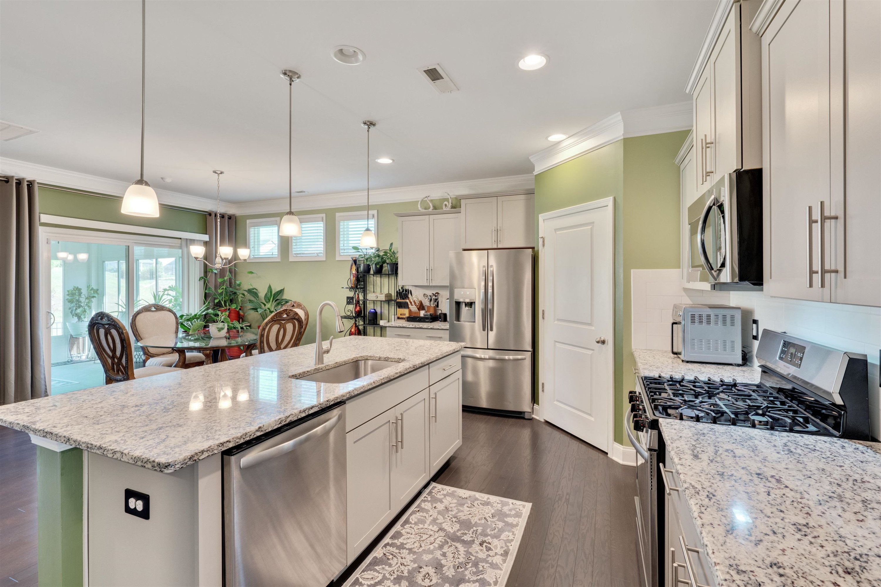 5317 Maplemoor Way Raleigh, NC 27616 - Photo 9 of 25 a kitchen with stainless steel appliances granite countertop a sink a stove and refrigerator