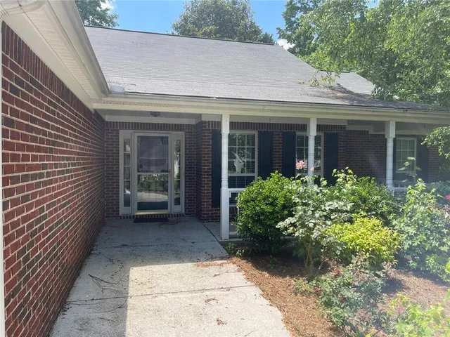 a view of a house with potted plants