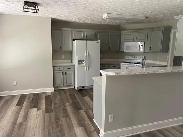 a kitchen with a refrigerator a stove and a sink