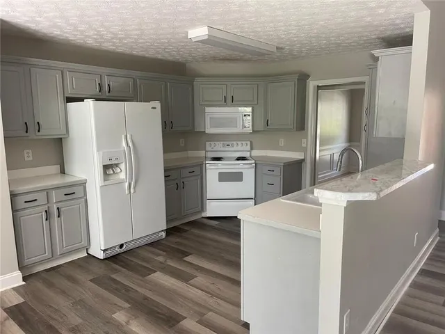 a kitchen with stainless steel appliances a refrigerator sink and cabinets