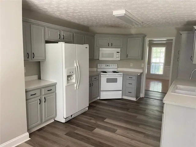 a kitchen with stainless steel appliances a refrigerator sink and cabinets