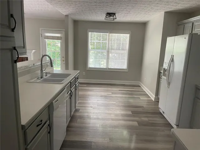 a bathroom with sink a mirror a bathtub and window
