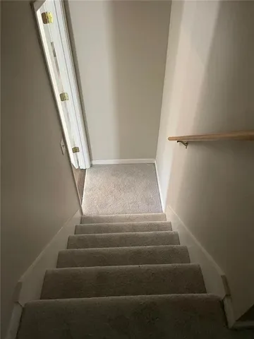 a view of staircase with white walls