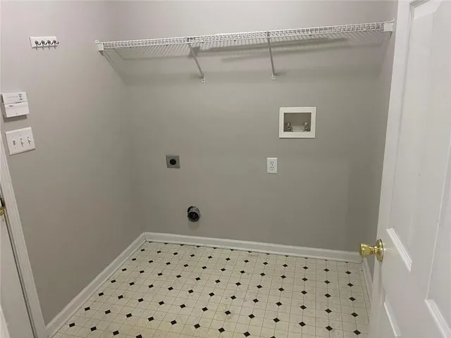 a bathroom with a shower and a tiled wall