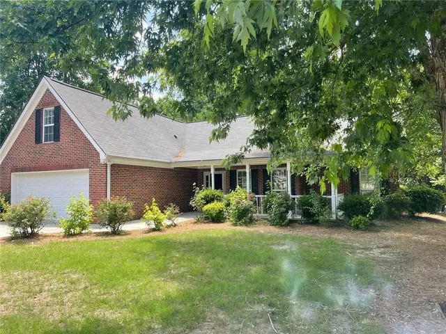 a front view of a house with garden