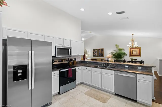 a kitchen with a sink stainless steel appliances and refrigerator