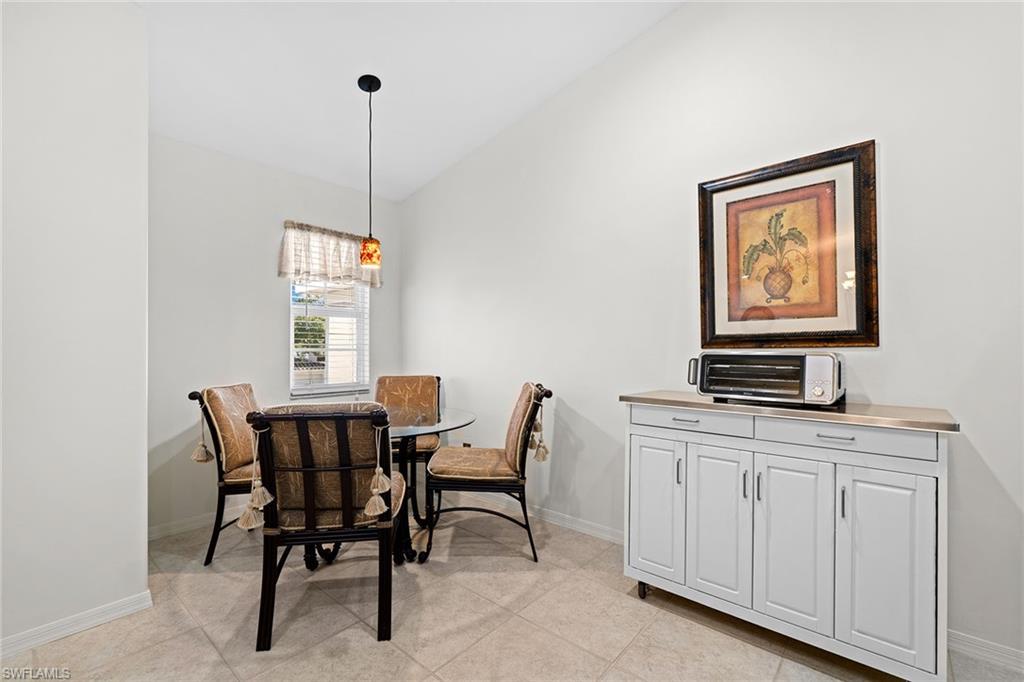 23785 Clear Spring Court, Unit 2305 Estero, FL 34135 - Photo 12 of 30 a dining room with furniture and window