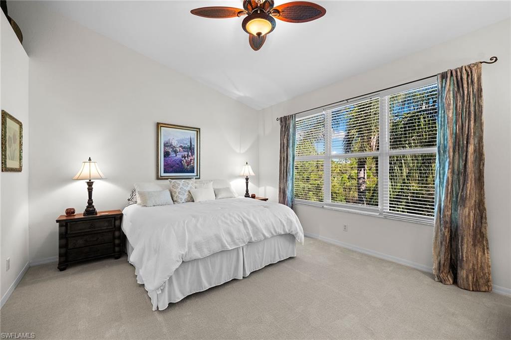 23785 Clear Spring Court, Unit 2305 Estero, FL 34135 - Photo 13 of 30 a bedroom with a bed lamps and window
