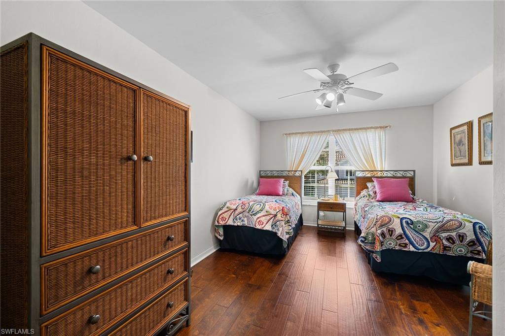23785 Clear Spring Court, Unit 2305 Estero, FL 34135 - Photo 17 of 30 a bedroom with bed and a chandelier