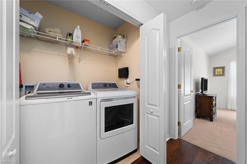 23785 Clear Spring Court, Unit 2305 Estero, FL 34135 - Photo 23 of 30 a view of washer and dryer with kitchen in the background
