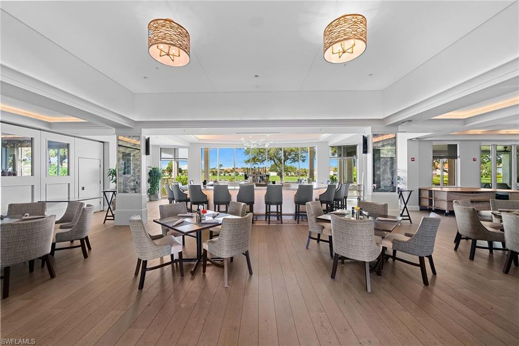 23785 Clear Spring Court, Unit 2305 Estero, FL 34135 - Photo 28 of 30 a view of a dining room with furniture window and wooden floor