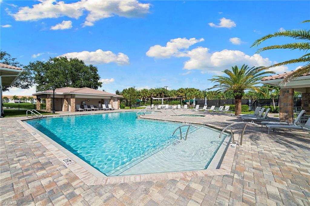 23785 Clear Spring Court, Unit 2305 Estero, FL 34135 - Photo 30 of 30 a view of a swimming pool with a lounge chairs