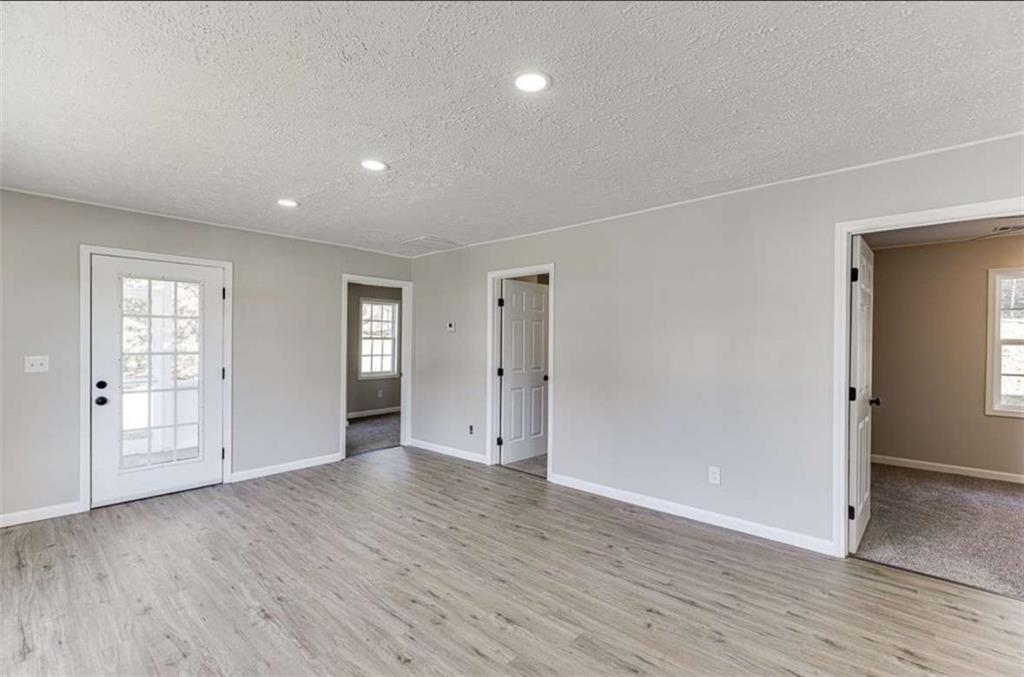 5554 Yonah Homer Road Alto, GA 30510 - Photo 12 of 25 an empty room with wooden floor and windows