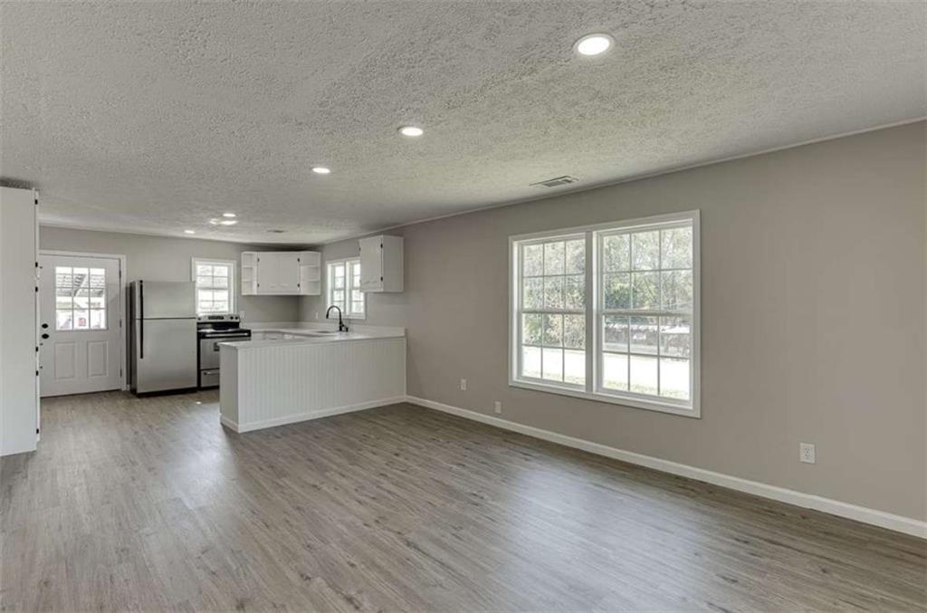 5554 Yonah Homer Road Alto, GA 30510 - Photo 14 of 25 a view of an empty room with a window and wooden floor