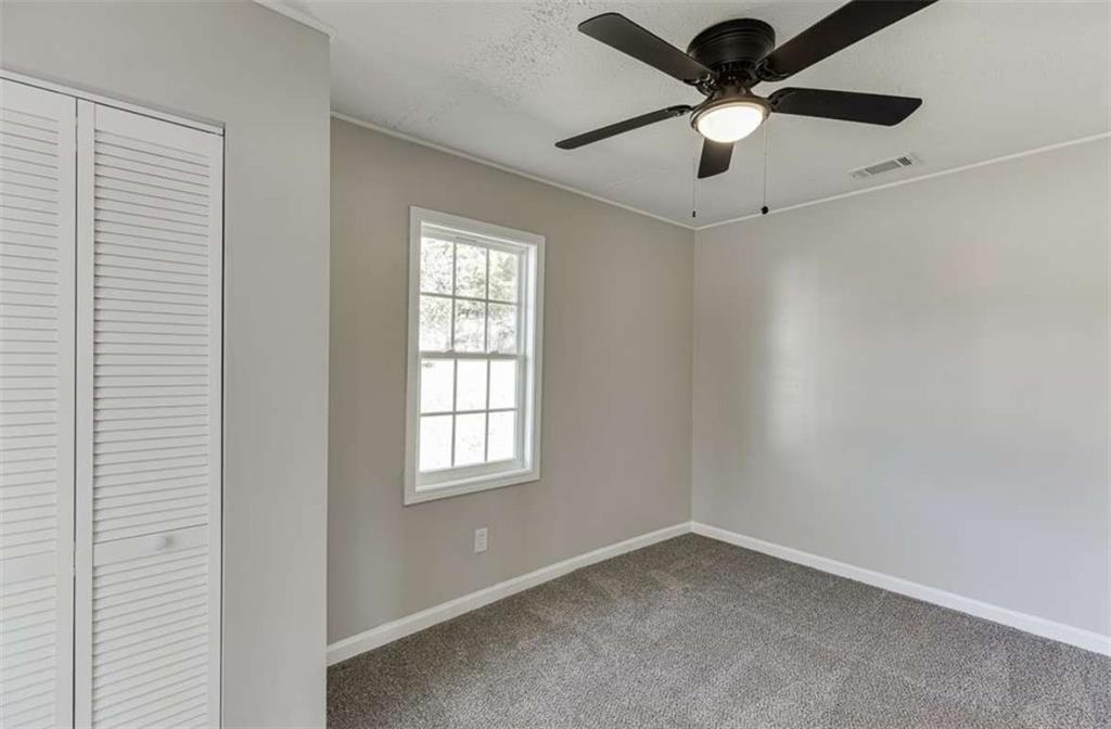 5554 Yonah Homer Road Alto, GA 30510 - Photo 15 of 25 an empty room with a window and a fan