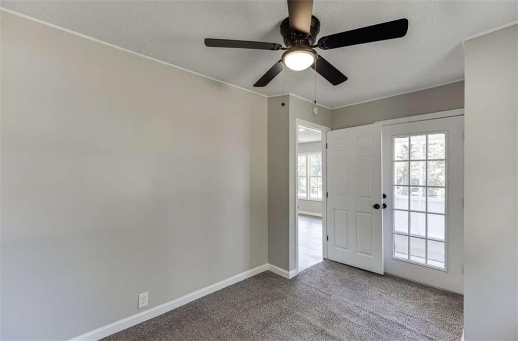 5554 Yonah Homer Road Alto, GA 30510 - Photo 16 of 25 an empty room with windows and fan