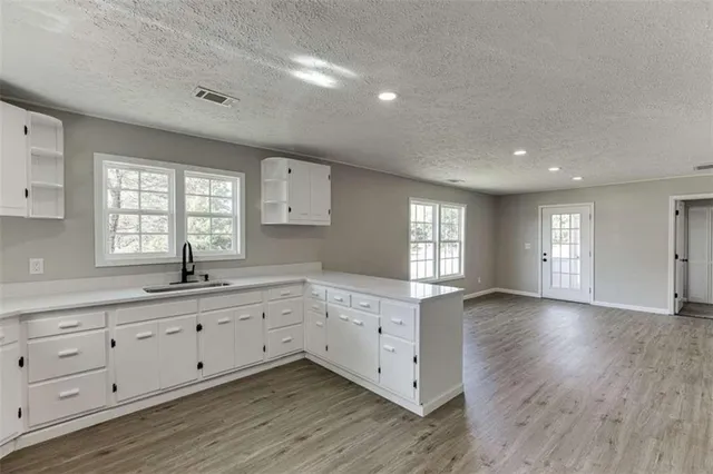 a open kitchen with cabinets stove and refrigerator