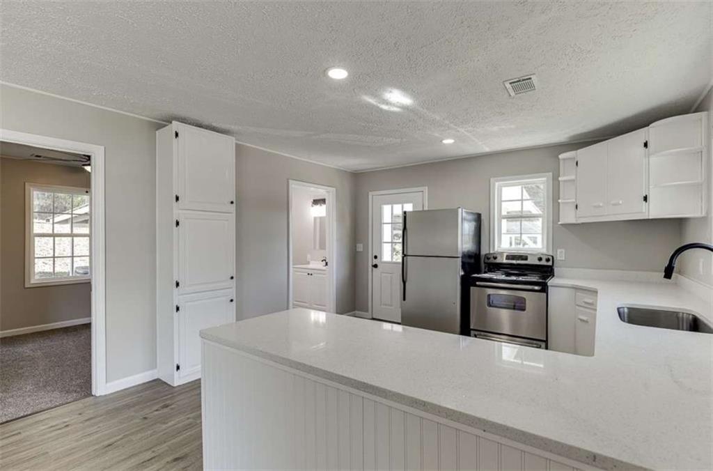 5554 Yonah Homer Road Alto, GA 30510 - Photo 4 of 25 a open kitchen with cabinets stove and refrigerator