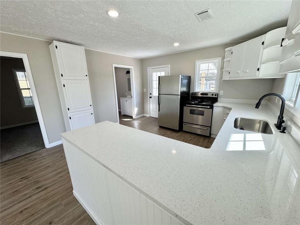 5554 Yonah Homer Road Alto, GA 30510 - Photo 8 of 25 a kitchen with refrigerator a stove a sink and a stove