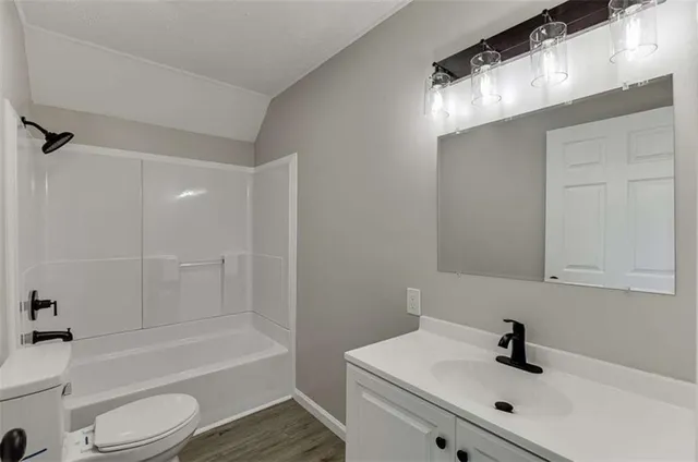 a bathroom with a sink mirror toilet and bathtub