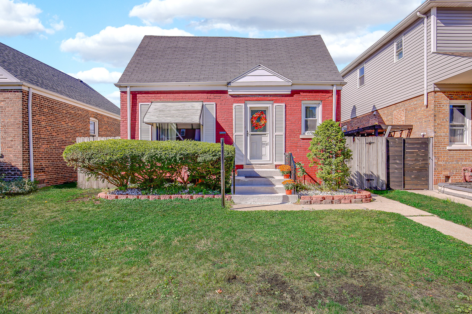 10922 South Ave B Chicago, IL 60617 - Photo 1 of 24 a front view of a house with a yard