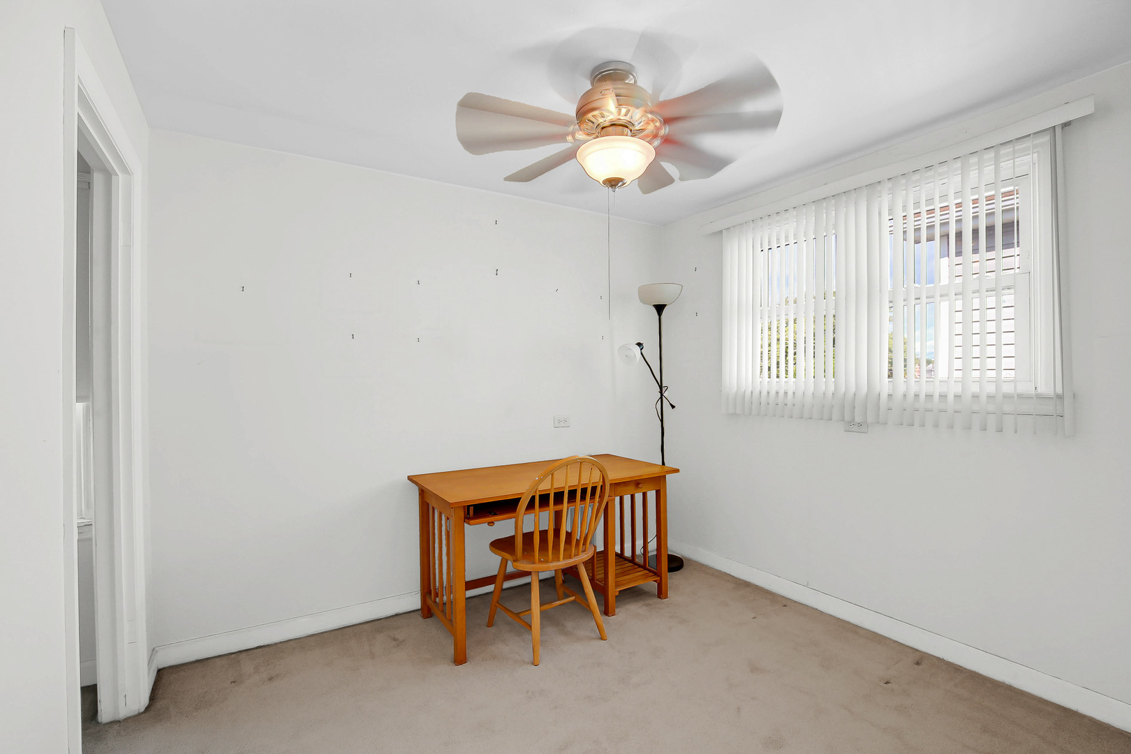 10922 South Ave B Chicago, IL 60617 - Photo 12 of 24 a chair and a table in a room